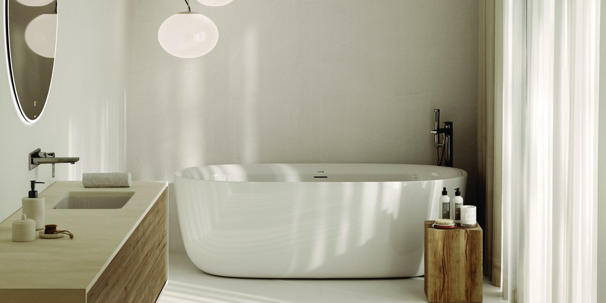 Freestanding bath in a bright room with an oval mirror and a wooden vanity