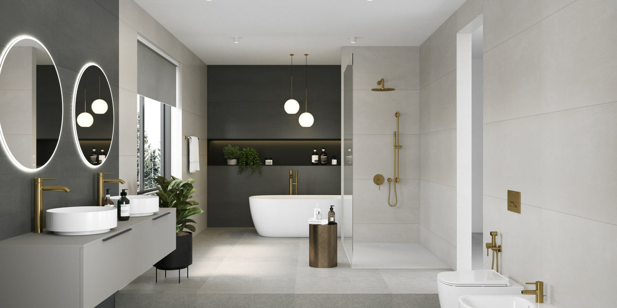 Bathroom with a double vanity, twin backlit mirrors and a freestanding bath, fitted in brushed gold