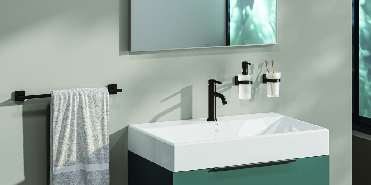 Wall-mounted accessories beside a vanity on a green bathroom wall