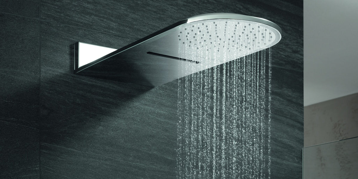 Wall-mounted head shower with a waterfall and a rain spray on a stone wall