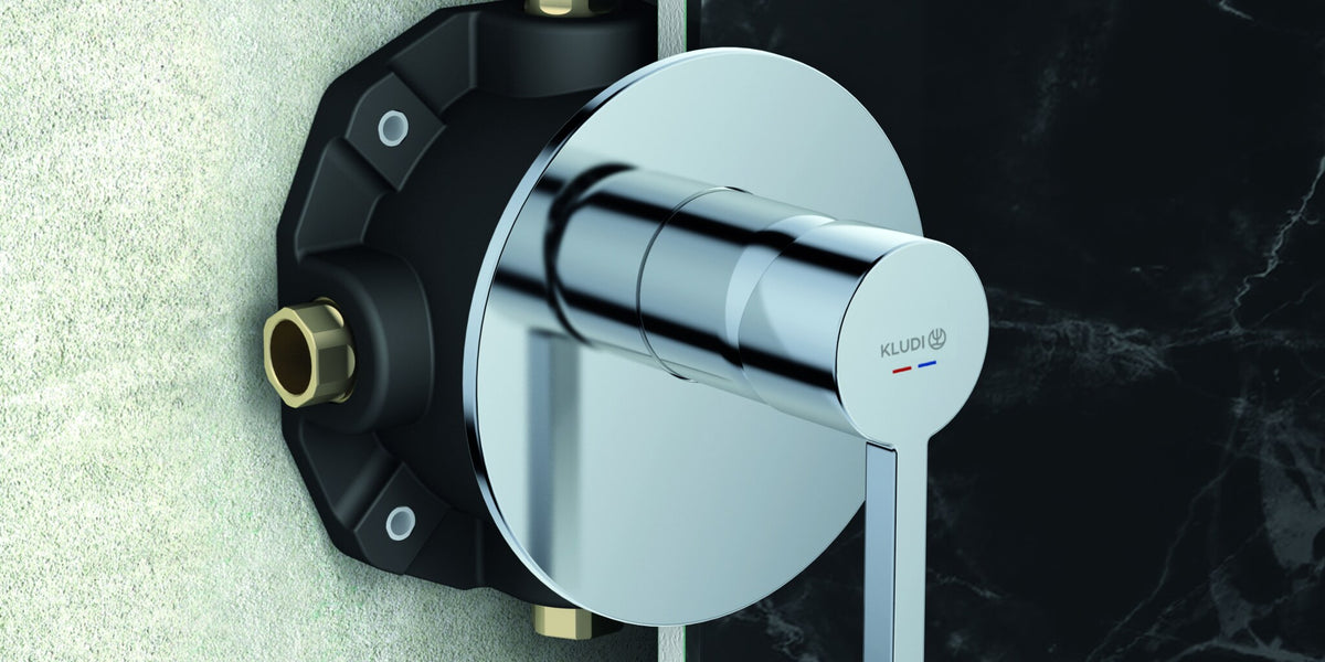 Concealed installation body set into a wall behind a single lever mixer