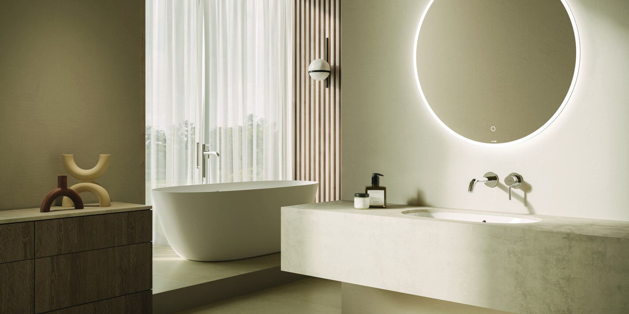 Bathroom with a round backlit mirror over a stone vanity and a freestanding bath