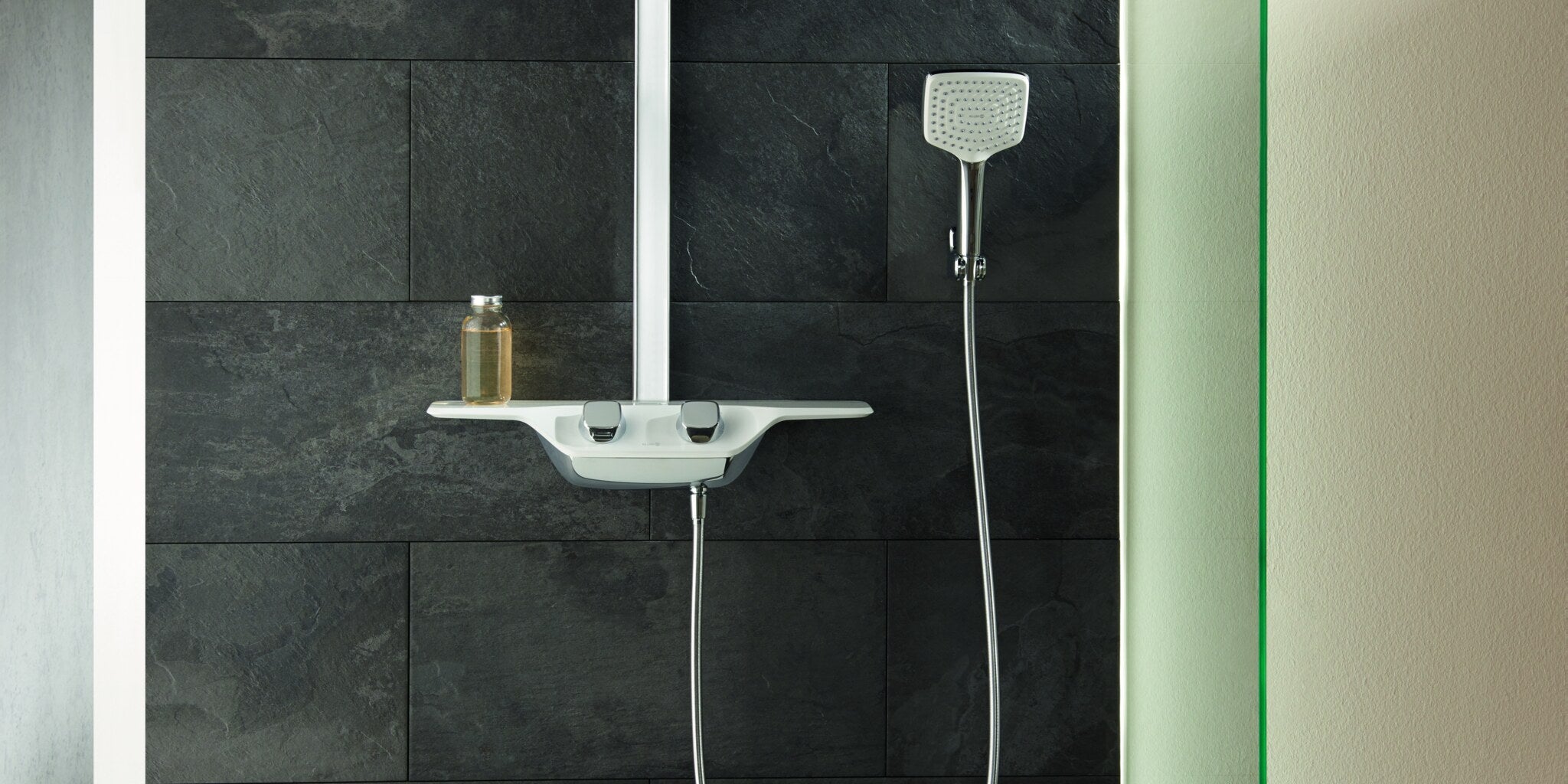 Shower column with a square head shower and a hand shower in a tiled shower