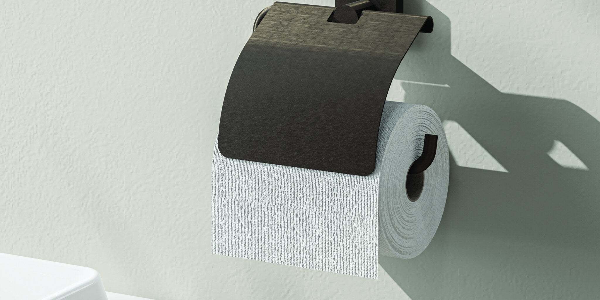 Paper holder in matt black on a white wall beside a WC