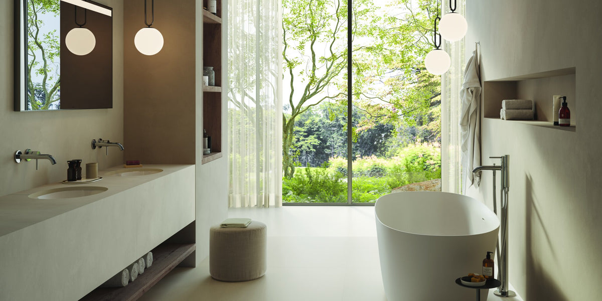Wide bathroom with a long vanity, a freestanding bath and a garden window